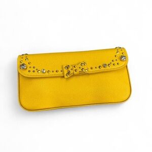 Miu Miu yellow hammered leather clutch with a jeweled bow and studs
